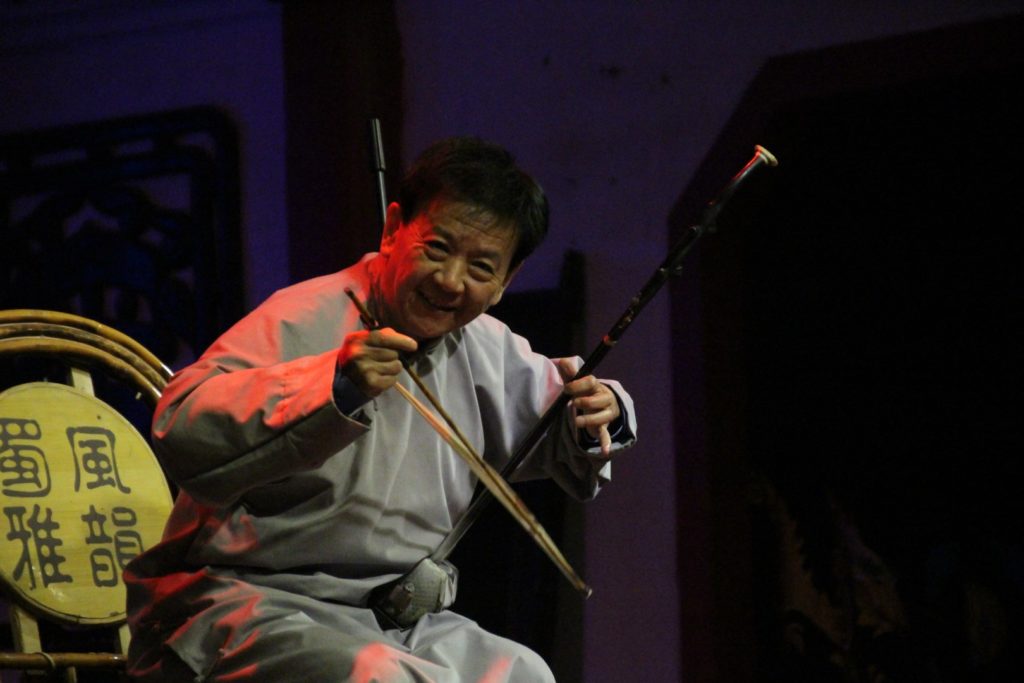This is a photo of a man playing erhu