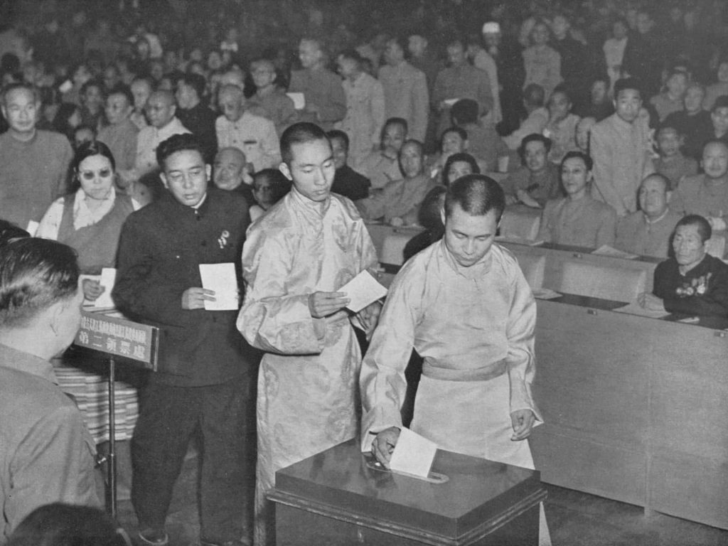 At the first National People’s Congress of the People’s Republic of China, the Dalai Lama and Panchen Lama cast their votes for the Constitution amidst complex political pressures.