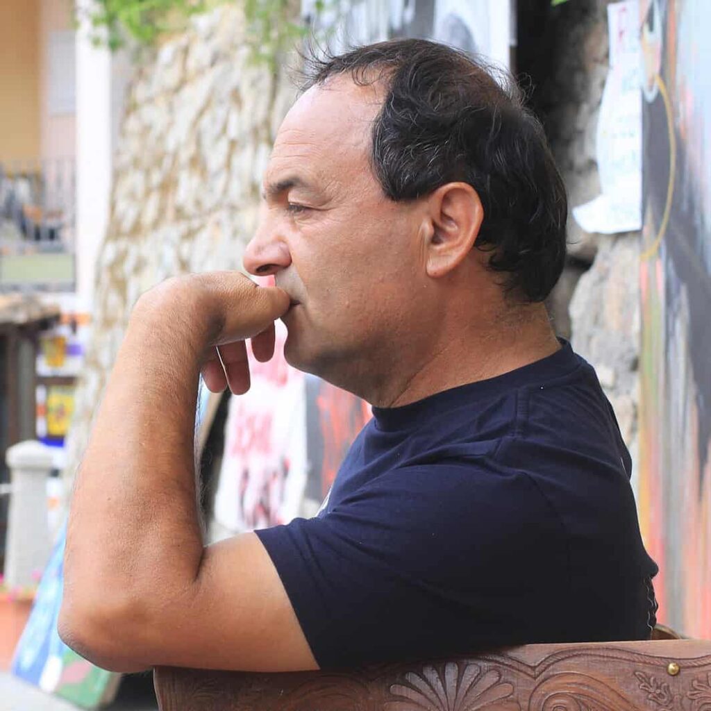 A photo of Domenico Lucano helping refugees and immigrants.