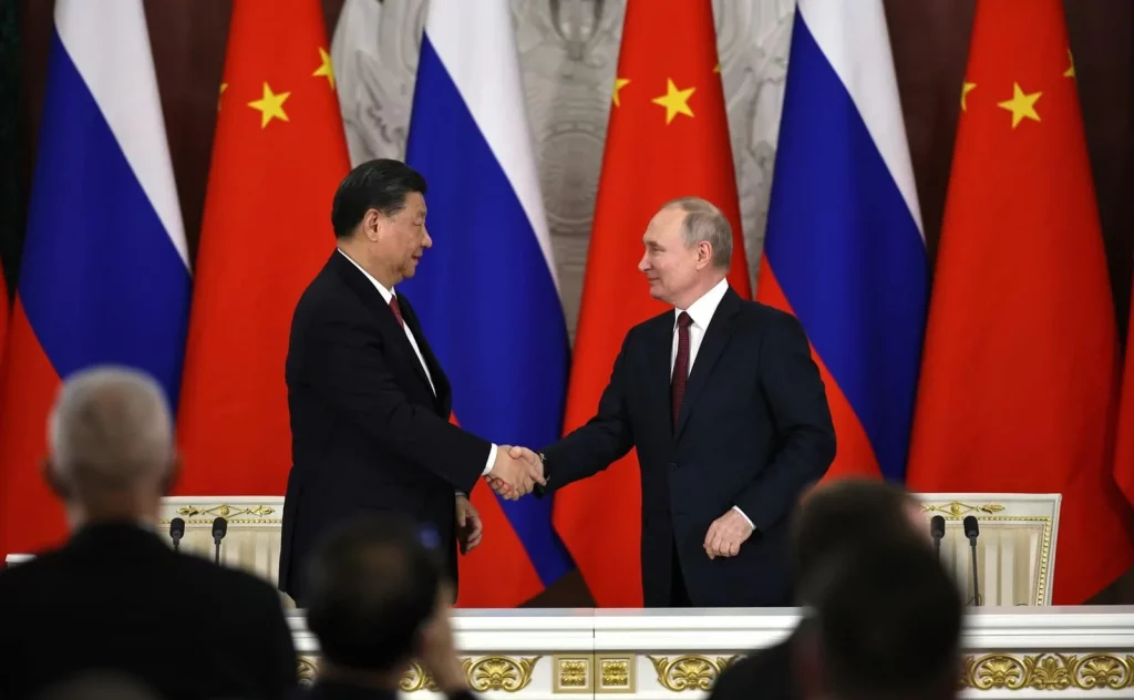 xi and putin shaking hands